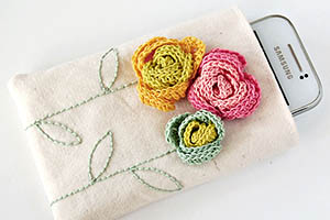 Phone pouch with crochet flowers